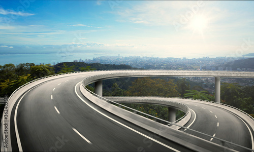 Highway overpass motion blur with nature mountain background during sunrise. photo