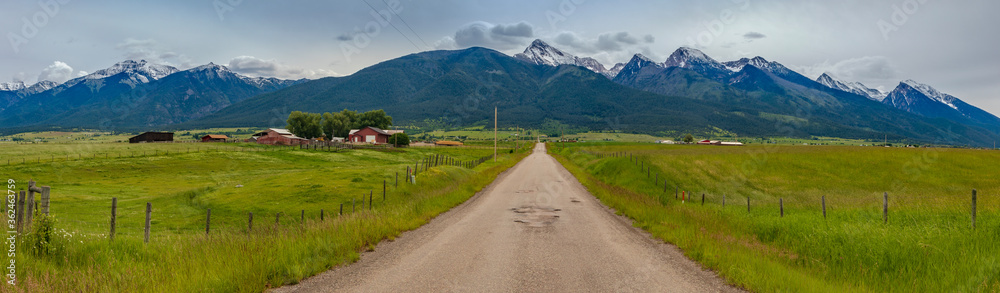 Panorama of country road heading to Mission Mountain range in Montana. Panorama of country road heading to Mission Mountain range in Montana.