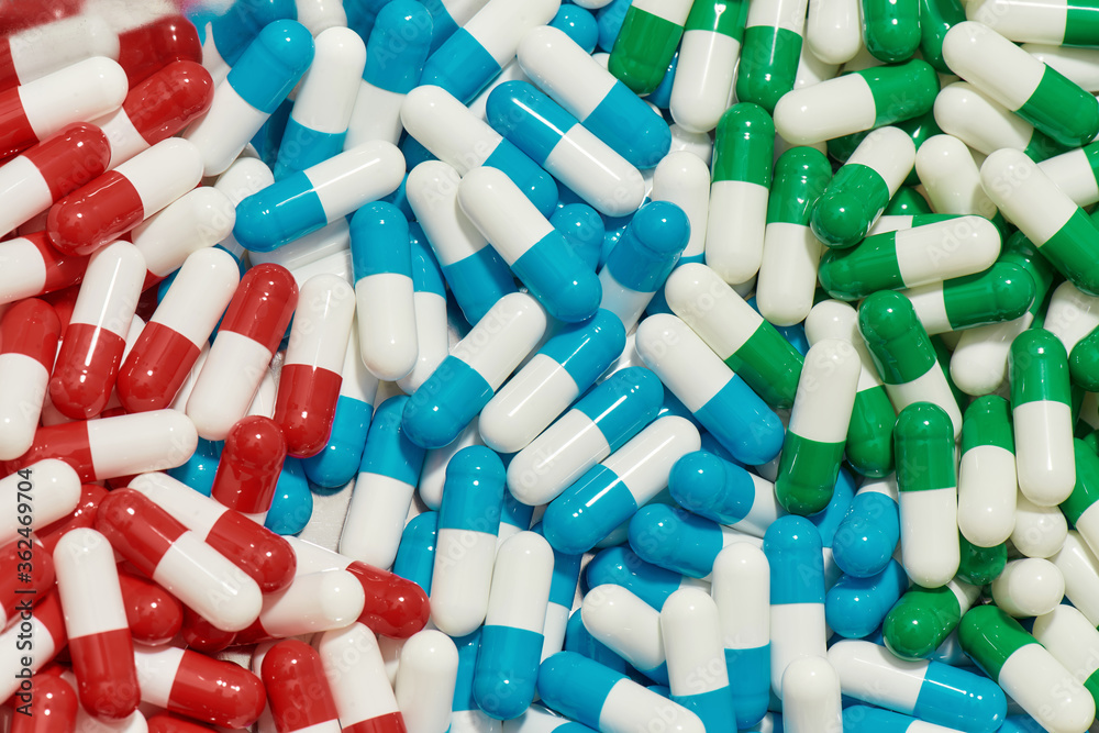 Close up of different pills, capsules lying randomly. Health care, vitamins and treatment concept Close up of different pills, capsules lying randomly. Health care, vitamins and treatment concept