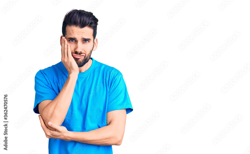 Young handsome man with beard wearing casual t-shirt thinking looking tired and bored with depression problems with crossed arms. Young handsome man with beard wearing casual t-shirt thinking looking tired and bored with depression problems with crossed arms.