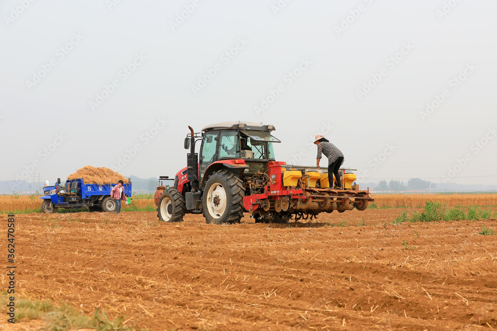 Tractors grow corn in no-tillage operations, Luannan County, Hebei Province, China Tractors grow corn in no-tillage operations, Luannan County, Hebei Province, China