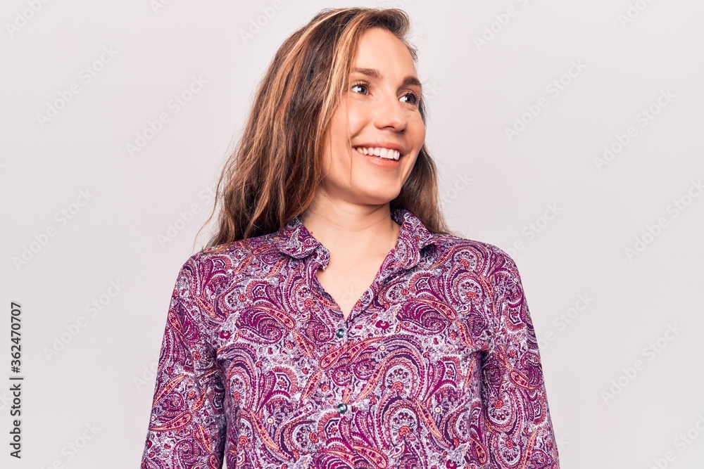 Young beautiful blonde woman wearing boho shirt standing over isolated background looking to side, relax profile pose with natural face and confident smile. Young beautiful blonde woman wearing boho shirt standing over isolated background looking to side, relax profile pose with natural face and confident smile.