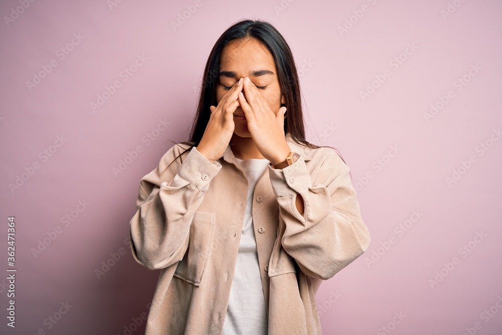 Young beautiful asian woman wearing casual shirt standing over pink background rubbing eyes for fatigue and headache, sleepy and tired expression. Vision problem Young beautiful asian woman wearing casual shirt standing over pink background rubbing eyes for fatigue and headache, sleepy and tired expression. Vision problem