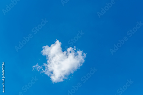 Romantic lonely cloud in the shape of a heart on a blue sky. Love concept