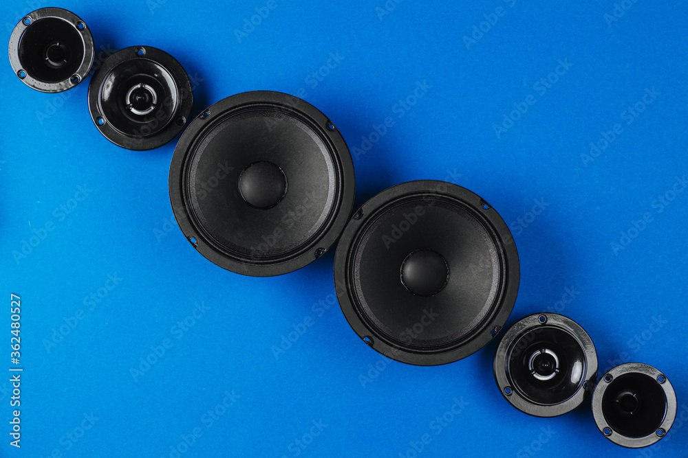 Car audio, car speakers, black subwoofer on a blue background. Copy space Car audio, car speakers, black subwoofer on a blue background. Copy space