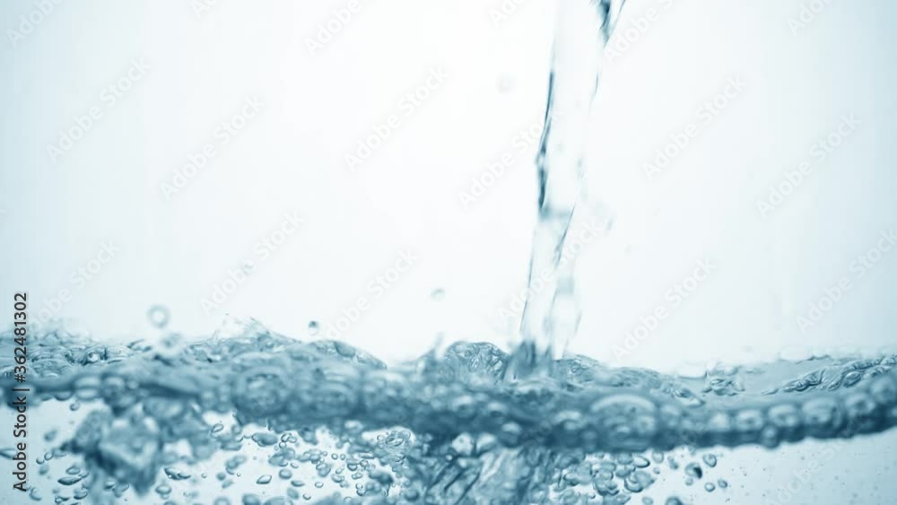 arbonated stream of water in slow motion falls on smooth clean surface, creating air bubbles, drop splashes and ripples after falling, side view. Freshness of a clear blue liquid on white background arbonated stream of water in slow motion falls on smooth clean surface, creating air bubbles, drop splashes and ripples after falling, side view. Freshness of a clear blue liquid on white background