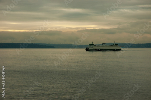 Ferry in Puget Sound in foggy weather and gloomy sunset