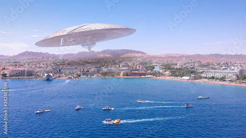 Alien ufo Saucers over Large Vacation City desert near sea,Aerial Red sea, Eilat city, Israel Drone view with visual effect Elements, summer 
