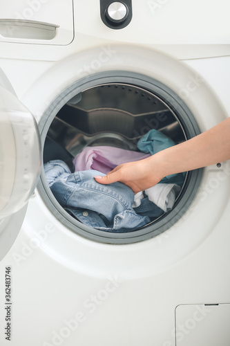 Woman doing laundry at home © Pixel-Shot