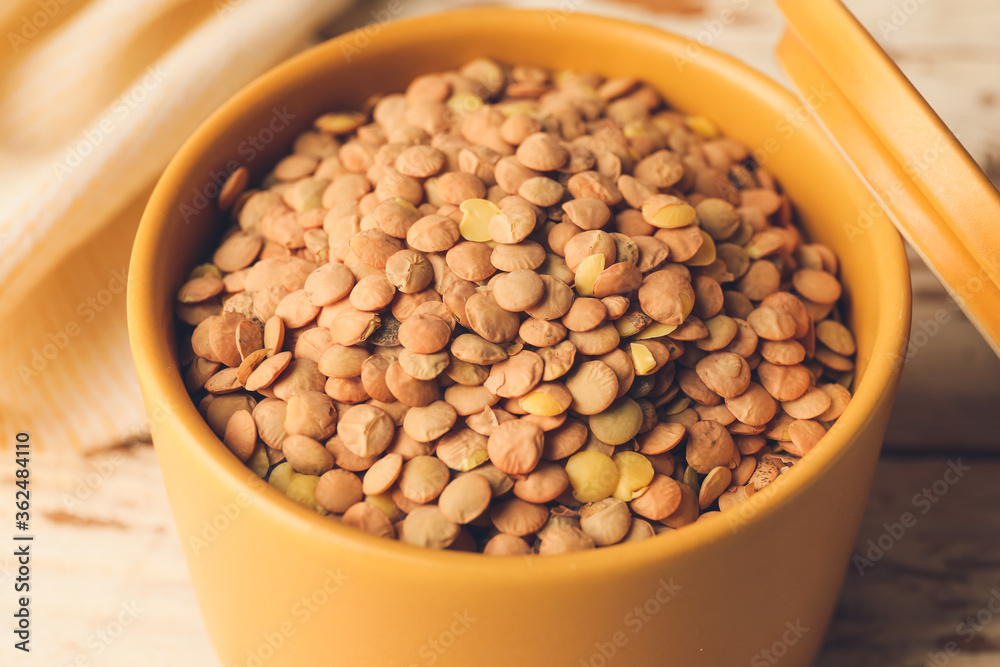 Raw lentils in box on table, closeup Raw lentils in box on table, closeup