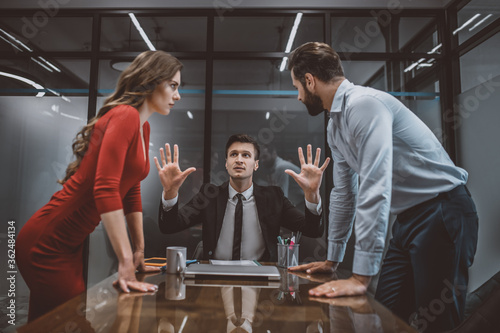 Lawyer trying to stop the argument between spouses photo