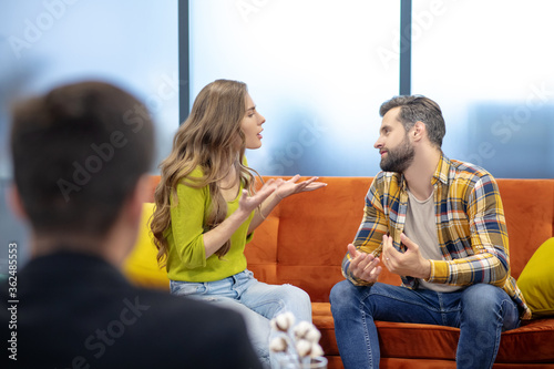 Young couple having an argument during the psychotherapeutic session