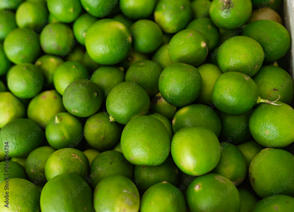 green limes in the fruit market. green limes in the fruit market.