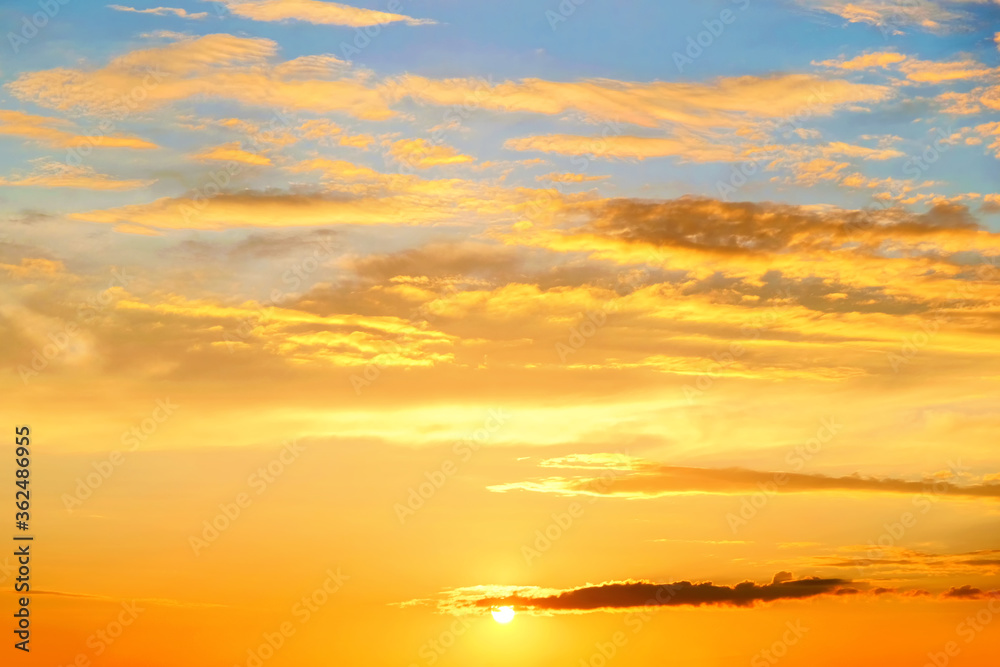 calm sunset sky landscape panorama background. Natural color of blue and yellow evening panoramic cloudscape with setting sun above horizon. Wide view