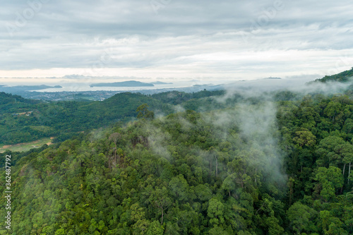 Aerial view drone shot of mountain tropical rainforest,Bird eye view image over the clouds Amazing nature background with clouds and mountain peaks.