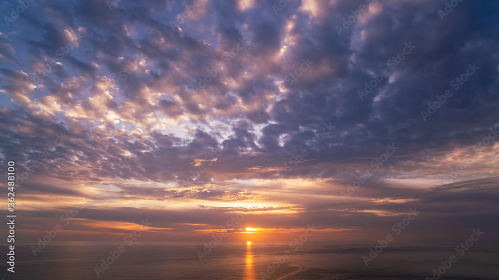 Beautiful light sunset or sunrise over sea scenery nature background with reflex in the water surface Amazing landscape.