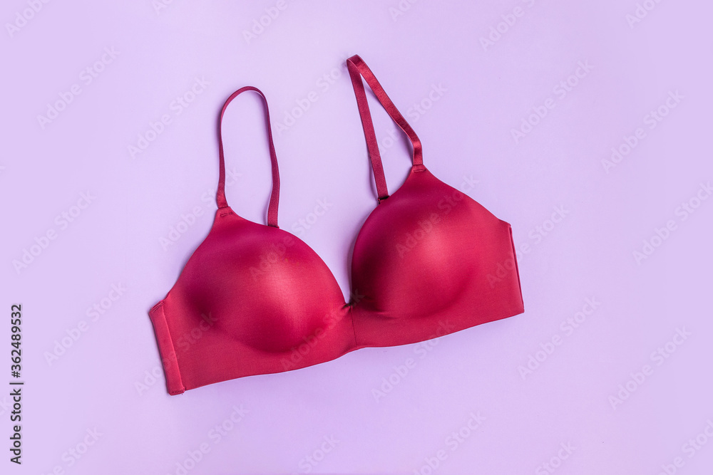 Beautiful smooth burgundy bra on a lilac background Beautiful smooth burgundy bra on a lilac background
