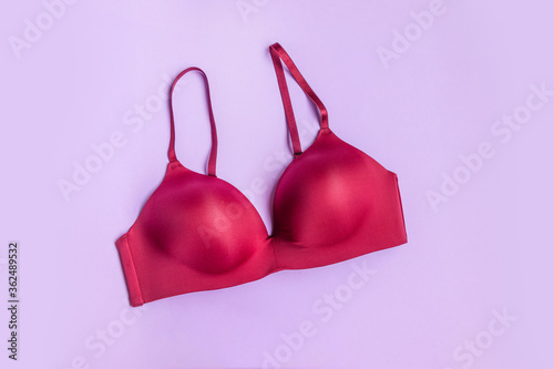 Beautiful smooth burgundy bra on a lilac background