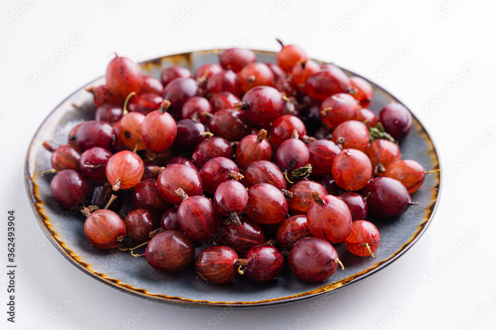 Close up shot of red gooseberry harvest. Healthy lifestyle and eating. Vegan food Close up shot of red gooseberry harvest. Healthy lifestyle and eating. Vegan food