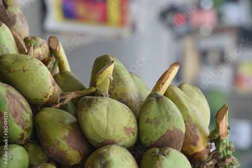 pile or group of coconuts on the cart at road for sells