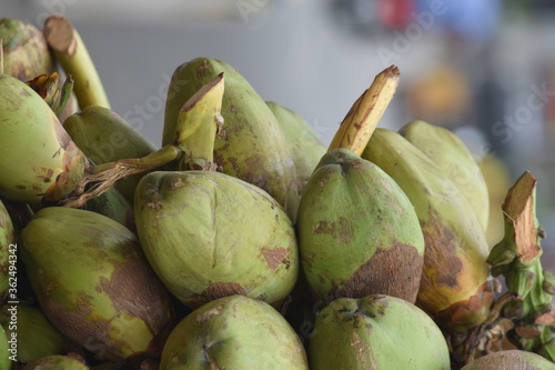 pile or group of coconuts on the cart at road for sells photo