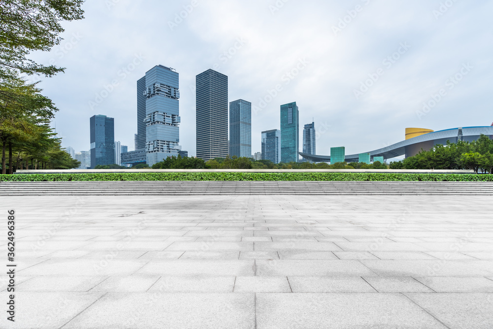 Panoramic skyline and buildings with empty concrete square floor Panoramic skyline and buildings with empty concrete square floor