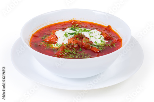 Red beetroot borscht seasoned with sour cream in bowl closeup