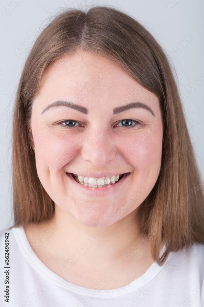 Pretty young plus size woman with friendly toothy smile.Beautiful Caucasian female model smiling in camera with white teeth and cheerful expression.Attractive cheeky girl with friendly smile Pretty young plus size woman with friendly toothy smile.Beautiful Caucasian female model smiling in camera with white teeth and cheerful expression.Attractive cheeky girl with friendly smile