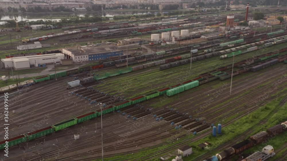 Large railway sorting station. A lot of cars, rails, buildings. View from the drone. Large railway sorting station. A lot of cars, rails, buildings. View from the drone.