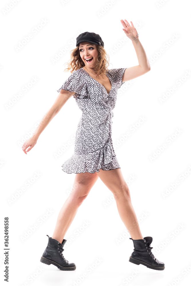 Joyful young stylish woman in airy dress leaving turning back and waving hand goodbye. Full length isolated on white background. Joyful young stylish woman in airy dress leaving turning back and waving hand goodbye. Full length isolated on white background.