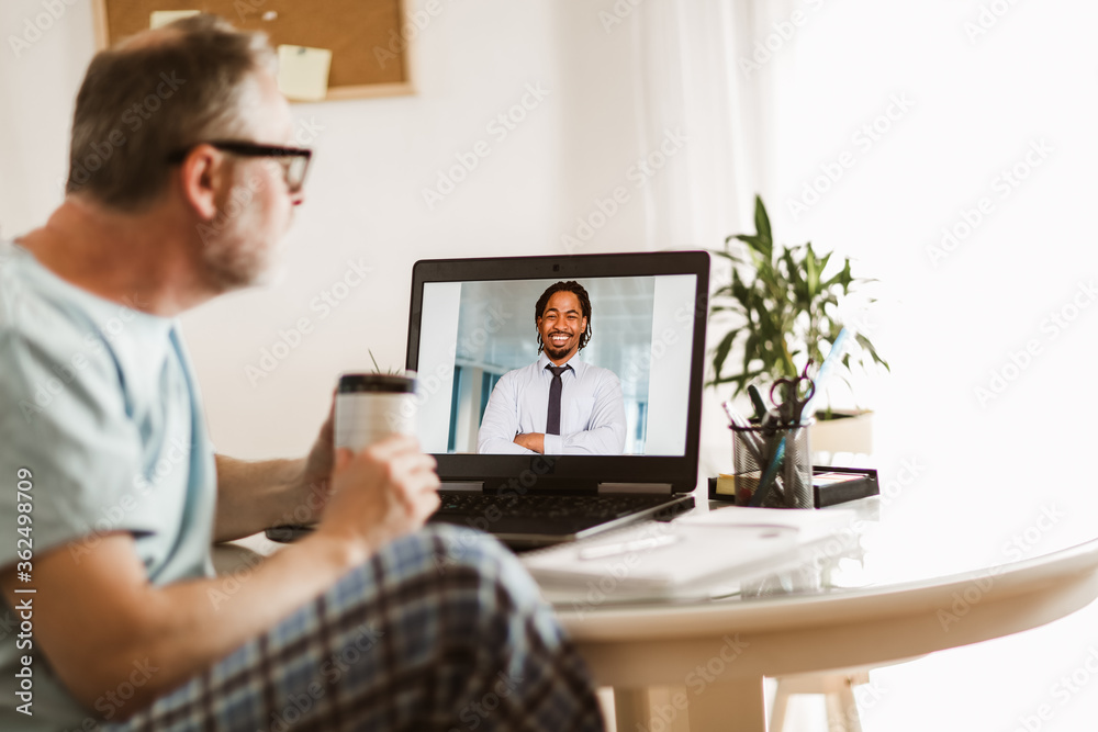 Businessman chatting with his colleague. Working at home.