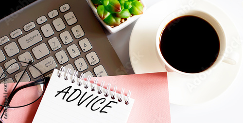 Office supplies, devices, coffee cup and glasses on white table with text ADVICE