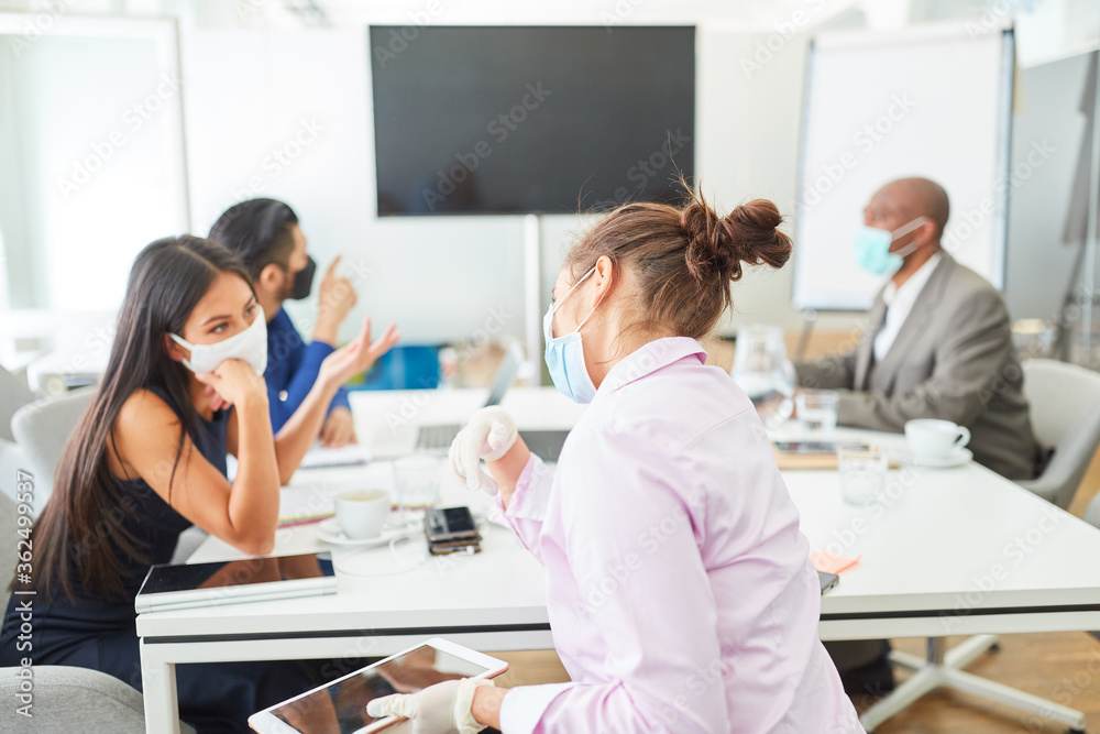 Business team with face mask in a meeting Business team with face mask in a meeting