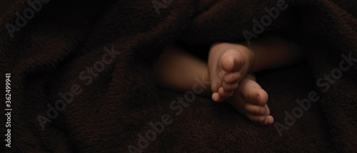 Принти на полотні Tiny feet newborn baby, dark background