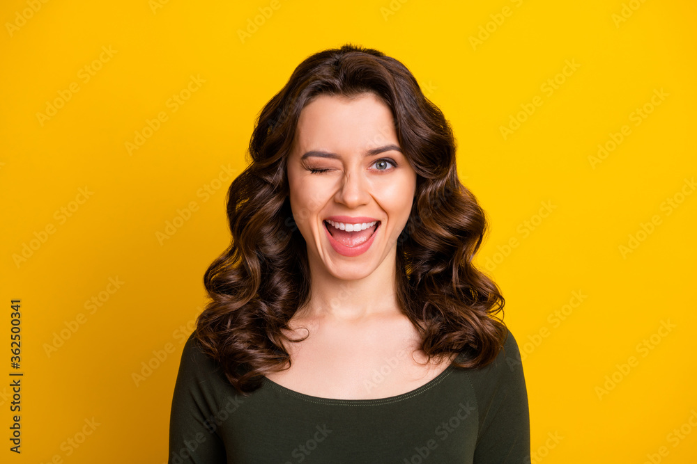 Close-up portrait of her she nice-looking attractive lovely lovable winsome glad flirty cheerful cheery wavy-haired lady winking isolated on bright vivid shine vibrant yellow color background