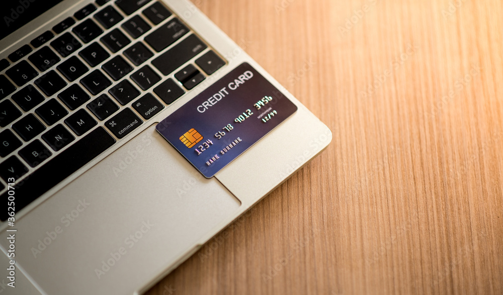 Close-up Credit Card on Laptop in the workplace. Business concept and Technology Digital for pay. Close-up Credit Card on Laptop in the workplace. Business concept and Technology Digital for pay.