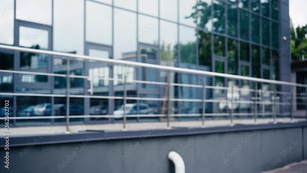 happy man in glasses waving hand near building happy man in glasses waving hand near building