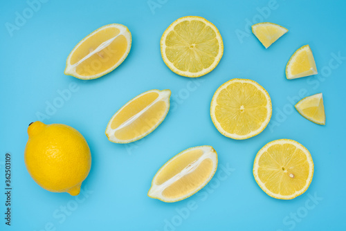 Fresh yellow lemons on blue background. Citrus background. 