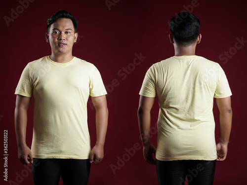 Front and rear portrait of a young man. Young male in blank yellow t-shirt, front and back view, isolated red background with clipping path. Design men tshirt template and mockup for print.