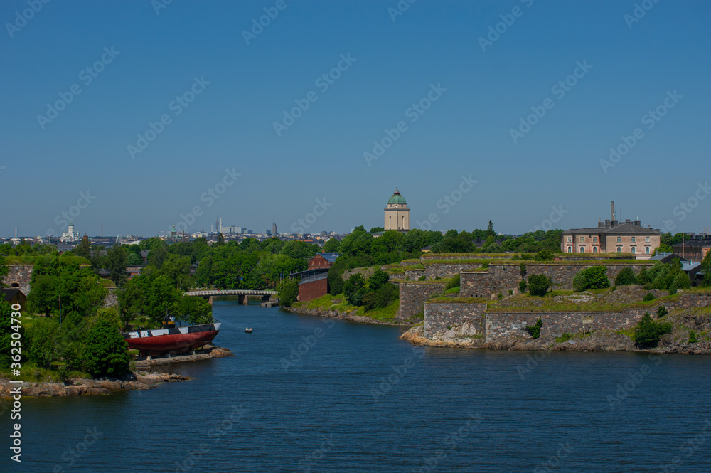 View of Helsinki and island on shore of Baltic Sea with city on background.