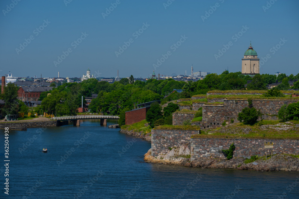 View of Helsinki and island on shore of Baltic Sea with city on background.