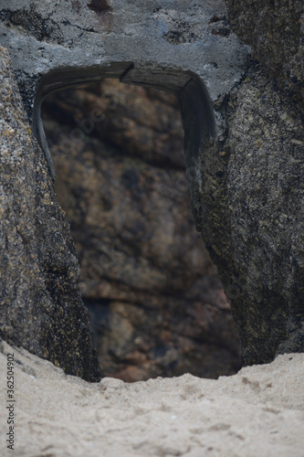 An archway between the cliffs at Porthcurno Cornwall