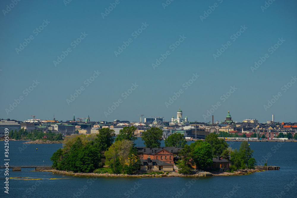 Helsinki / Finland - June 26 2020: View of Helsinki and island on shore of Baltic Sea with city on background.