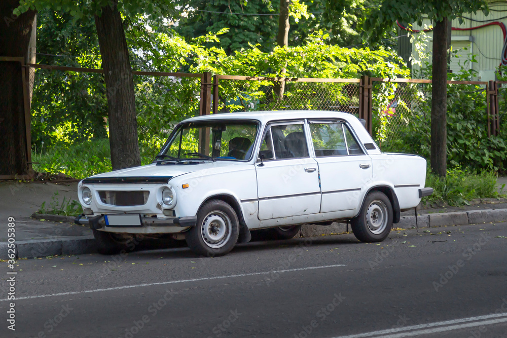 Old russian passenger car sedan on the road.