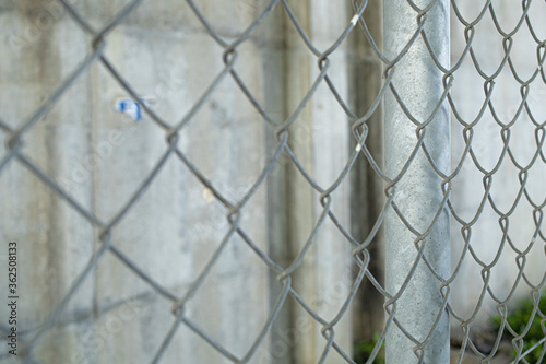 An old wire mesh with a diamond pattern.