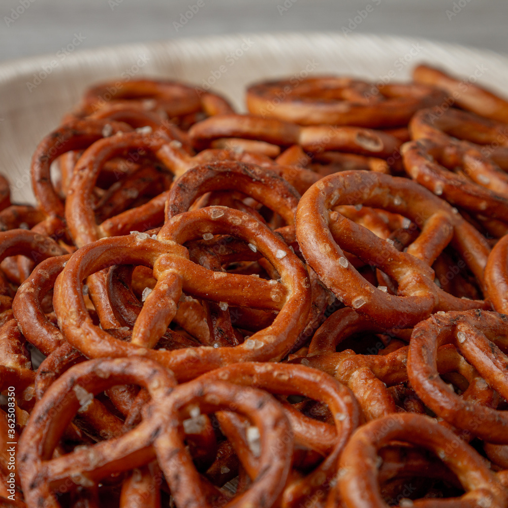 Pretzels on a plate on the kitchen table. Snack on beer. Salty snack. Crispy pretzels. Beer snacks Pretzels on a plate on the kitchen table. Snack on beer. Salty snack. Crispy pretzels. Beer snacks