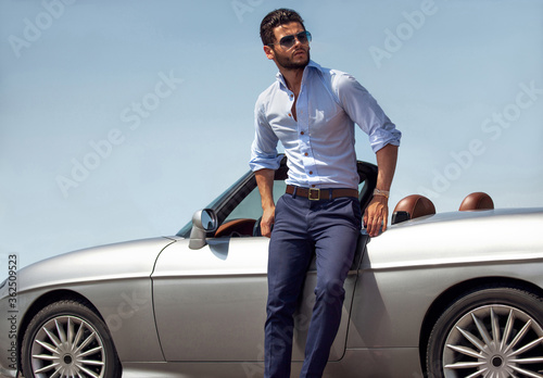Handsome man near the car. Luxury life. © ASjack