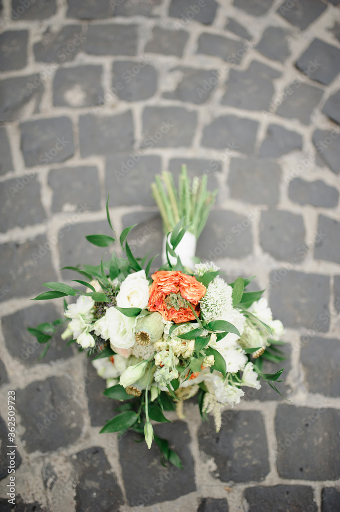 Bridal bouquet on the old paving stones.