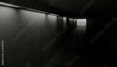 Dark interior of a subway with exit to the street