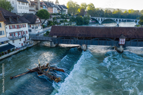 old bridge and flood in the river with uprooted tree